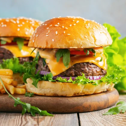 A two fresh homemade burgers and potato fries.